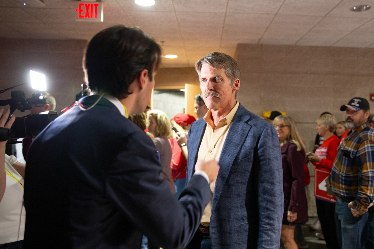 Eric Hovde talks to a journalist 