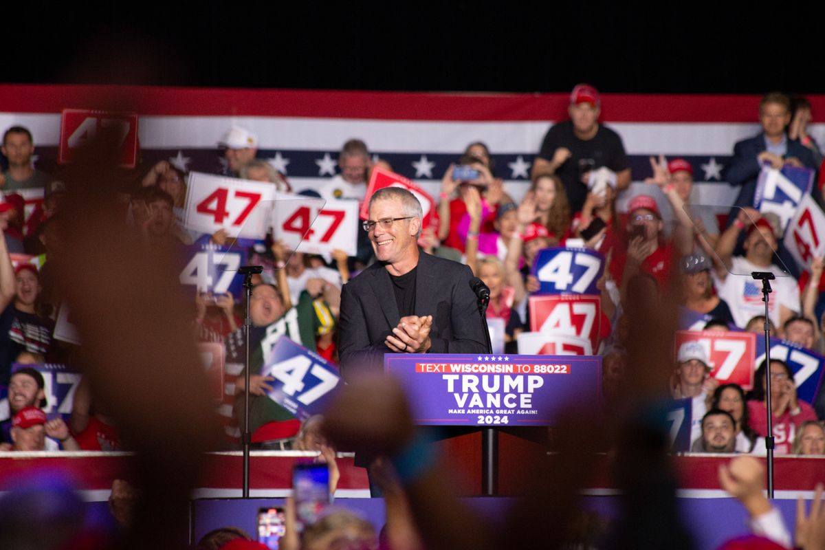 Brett Favre on stage speaking to the crowd at the Green Bay rally