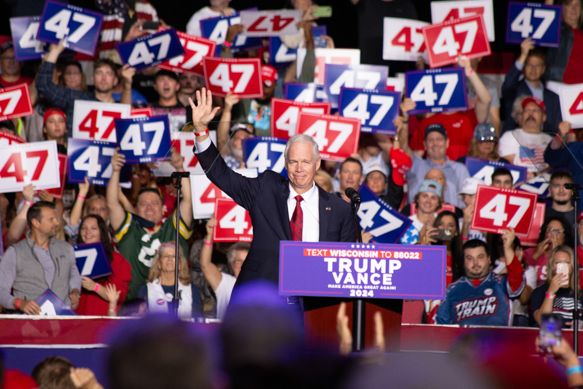 Ron Johnson speaking on stage at the Green Bay rally