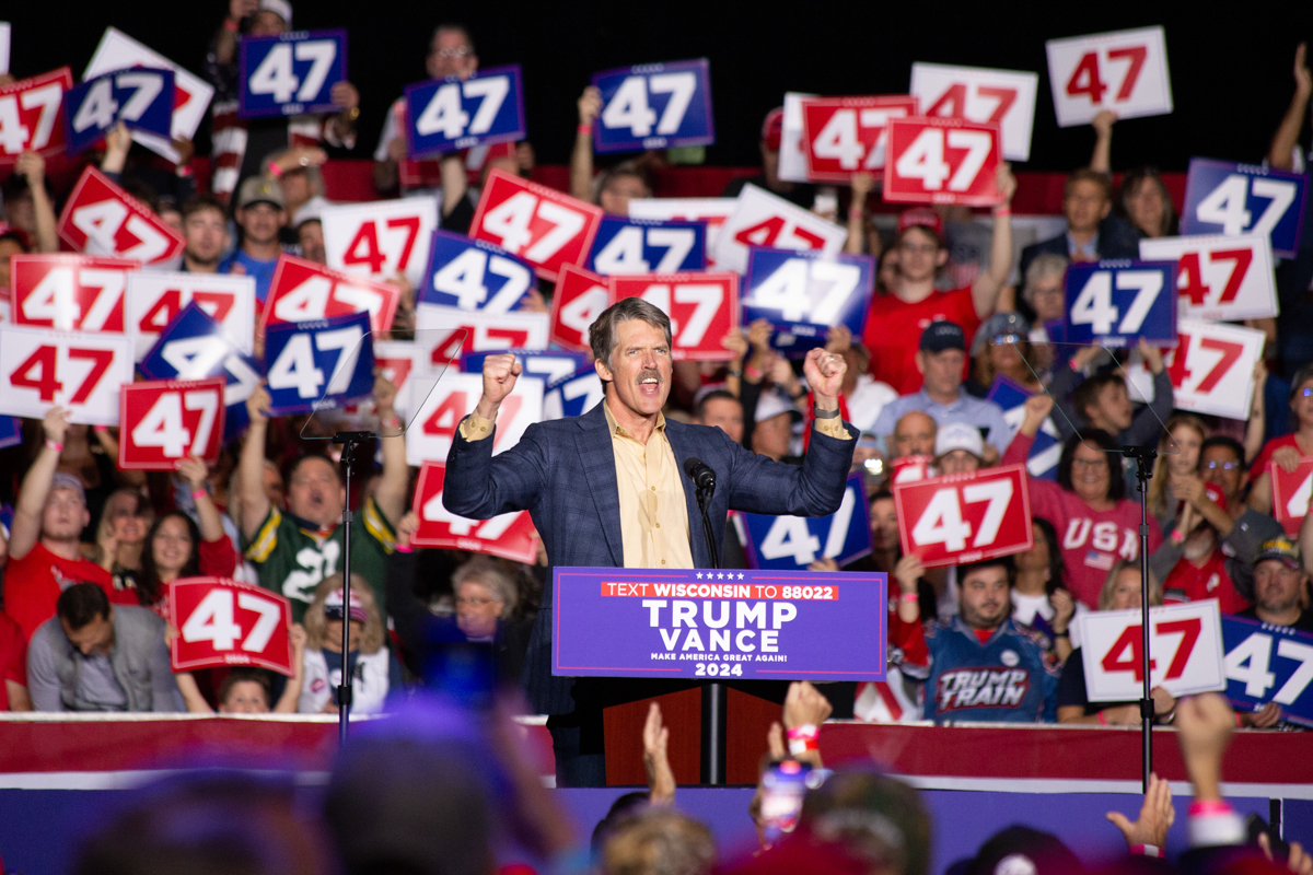 Eric Hovde speaking on stage at the Green Bay rally