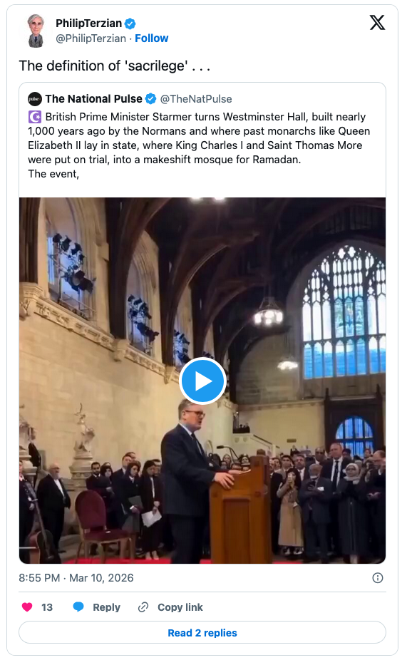A crowded room in Westminster Hall during an event, featuring a speaker at a podium, with attendees in formal attire observing.