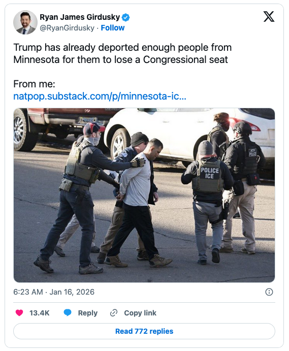 A man being escorted by law enforcement officials in a street setting, with police officers visible in tactical gear and one officer identified as part of ICE.