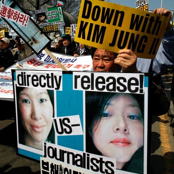 South Koreans protest against North Korea as they display pictures of the two American journalist, Euna Lee (right) and Laura Ling (left)  held captive. AP Images