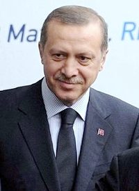 Turkish PM Visits Germany, Mocks Assimilation