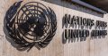 close up of UN logo and sign on the outside of a building