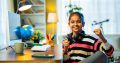Studious Indian Asian Elementary Grade Girl Attending Virtual Online Class at Home Using Computer, Learning and Communicating with Teacher, Highlighting Modern Education, E-Learning, and Technology